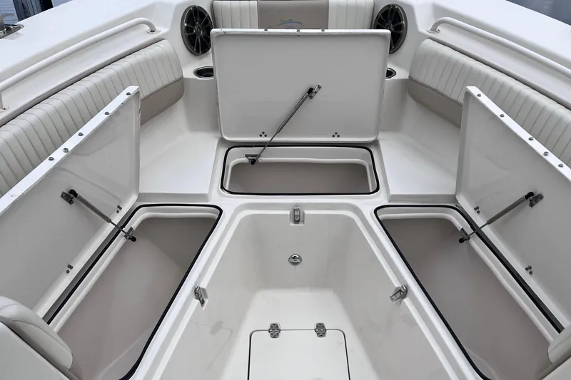 Slide: The Image of 2019 Sea Chaser 27 HFC boat with open storage compartments and seating area. - 10