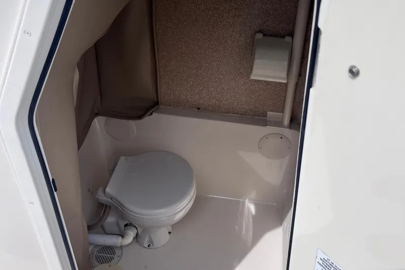 Slide: The Image of 2019 Sea Chaser 27 HFC boat interior with compact marine toilet. - 16
