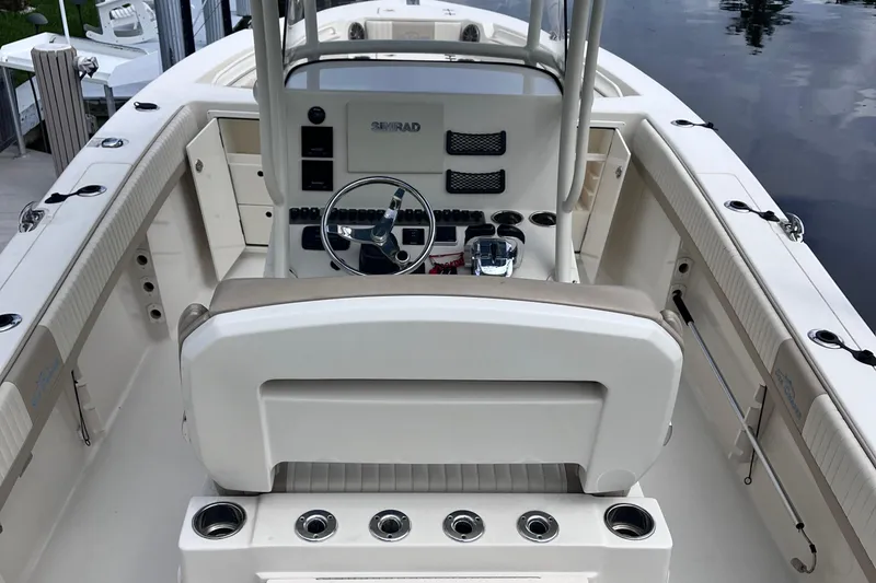 Slide: The Image of 2019 Sea Chaser 27 HFC boat interior with steering console and seating. - 5