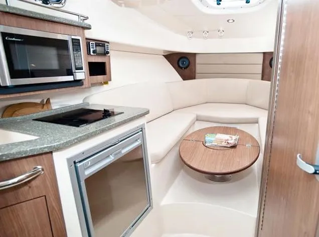 Slide: The Image of Manufacturer Provided Image: Interior of 2014 Boston Whaler 285 Conquest with kitchenette and seating area. - 11