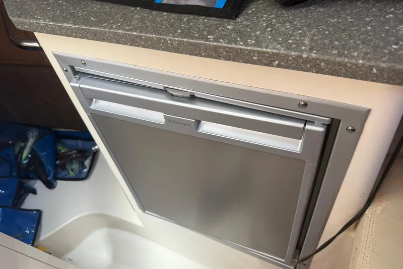Slide: The Image of Dometic refrigerator in 2014 Boston Whaler 285 Conquest boat interior. - 13