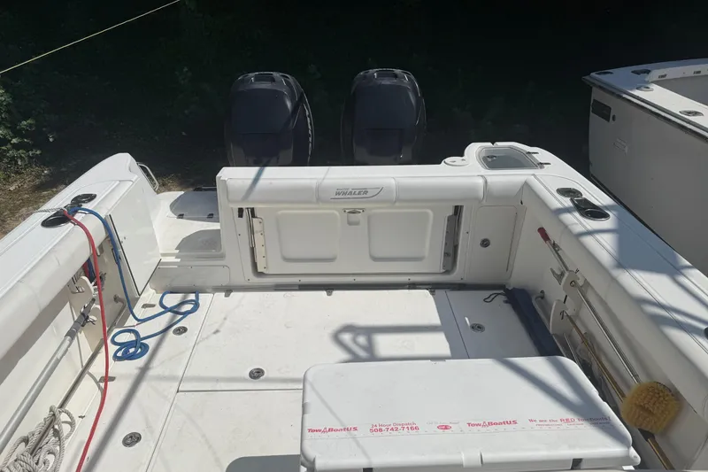 Slide: The Image of 2014 Boston Whaler 285 Conquest boat deck with dual engines and fishing equipment. - 5