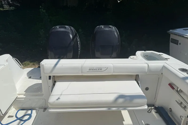 Slide: The Image of 2014 Boston Whaler 285 Conquest boat with dual outboard motors and seating area. - 6