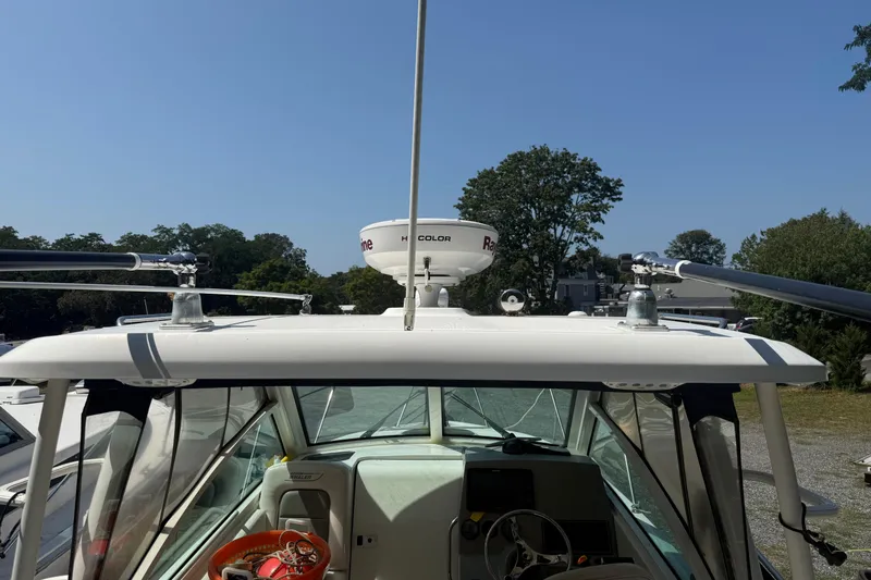 Slide: The Image of 2014 Boston Whaler 285 Conquest boat with radar equipment, docked outdoors. - 7