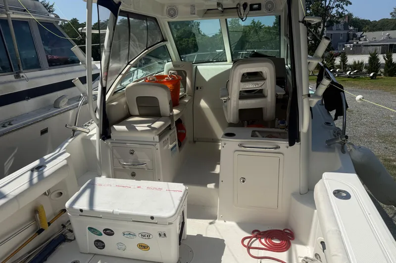 Slide: The Image of 2014 Boston Whaler 285 Conquest boat interior with seating and storage compartments. - 8