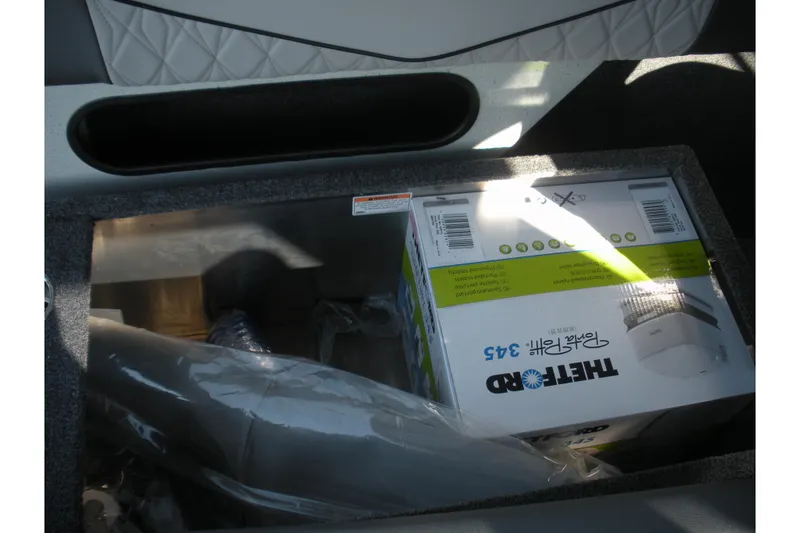 Slide: The Image of Interior seating of 2026 Duckworth 26 Pacific Pro boat, featuring gray and white upholstery. - 12