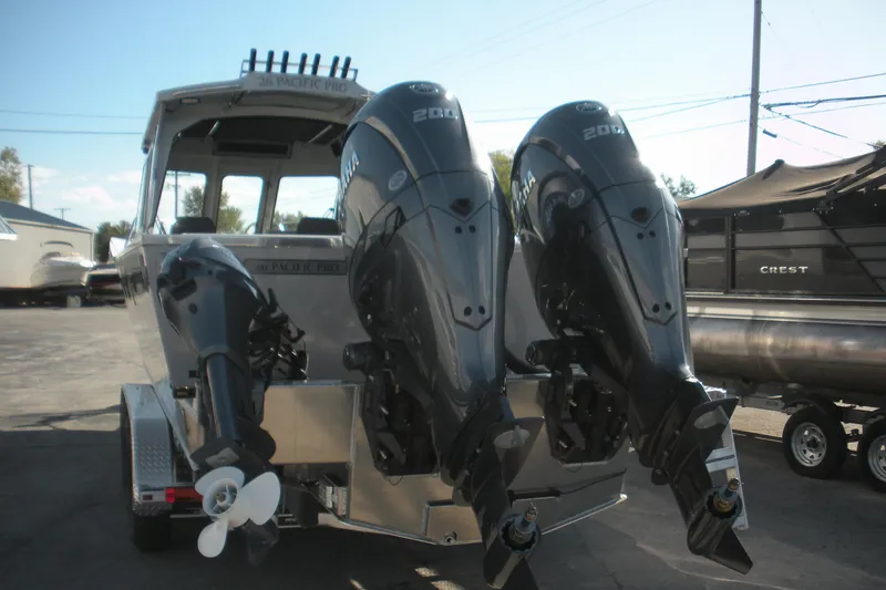 Slide: The Image of Interior view of 2026 Duckworth 26 Pacific Pro boat, showcasing spacious deck and storage compartments. - 19