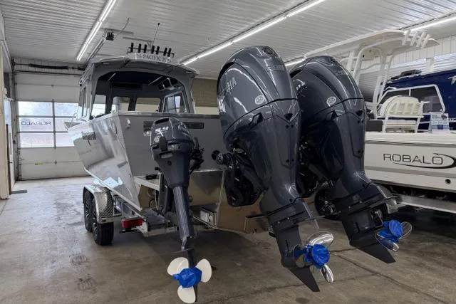 Slide: The Image of 2026 Duckworth 26 Pacific Pro boat with dual outboard engines in a showroom. - 22