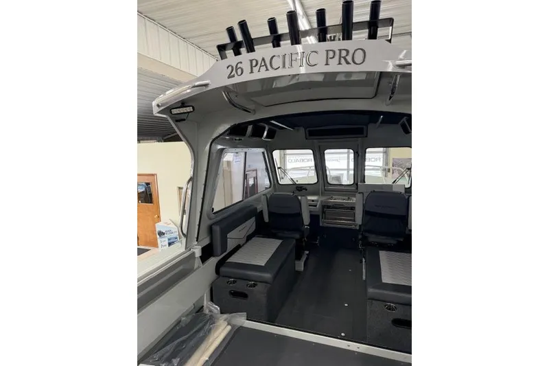 Slide: The Image of Interior view of 2026 Duckworth 26 Pacific Pro boat, showcasing seating and helm area. - 24