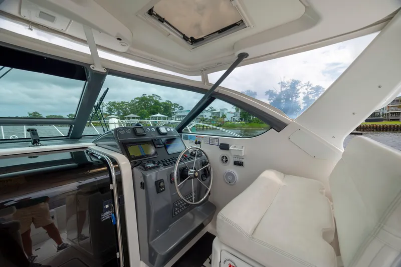 Slide: The Image of 2004 Tiara Yachts 3200 Open helm with modern controls and comfortable seating. - 10