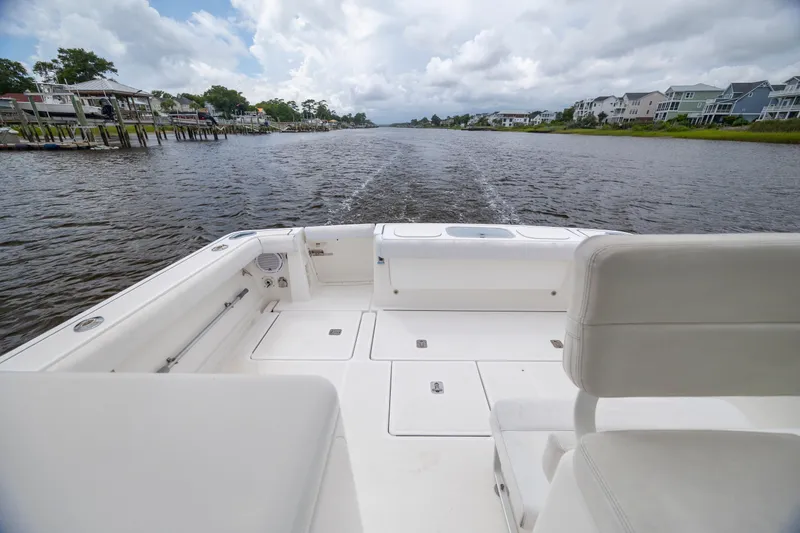 Slide: The Image of 2004 Tiara Yachts 3200 Open boat cruising on a scenic river. - 13