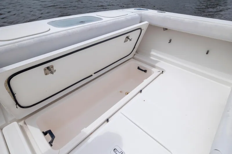 Slide: The Image of 2004 Tiara Yachts 3200 Open boat storage compartment, open on deck by water. - 18