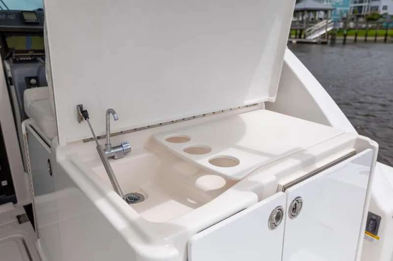 Slide: The Image of 2004 Tiara Yachts 3200 Open boat sink and storage area by the water. - 20