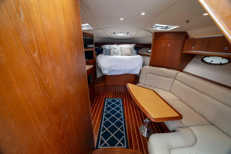 Slide: The Image of Luxurious 2004 Tiara Yachts 3200 Open interior with cozy bed and elegant seating area. - 27