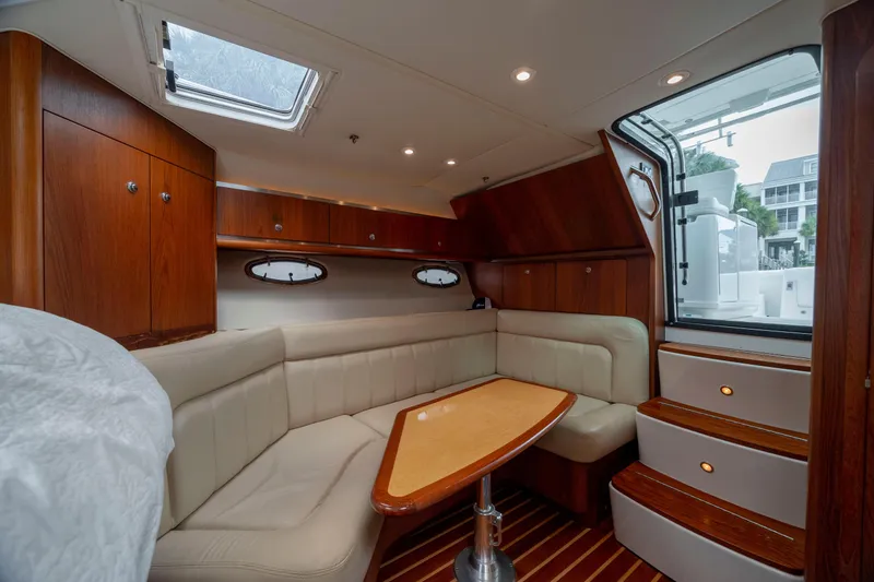 Slide: The Image of Luxurious interior of 2004 Tiara Yachts 3200 Open with elegant wood finish and plush seating. - 29