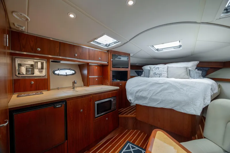 Slide: The Image of Luxurious interior of 2004 Tiara Yachts 3200 Open with cozy bed and kitchenette. - 33