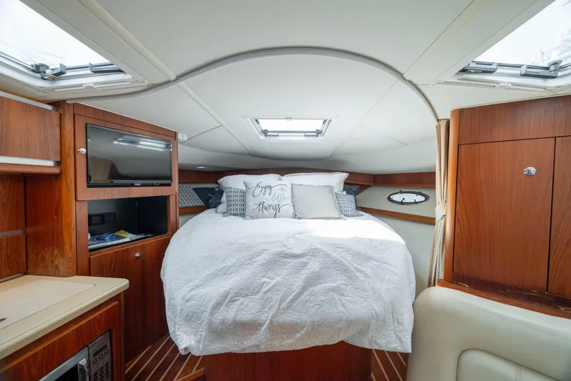 Slide: The Image of Luxurious cabin interior of 2004 Tiara Yachts 3200 Open with cozy bed and wood finish. - 34