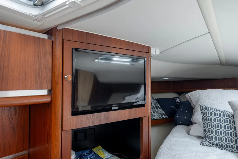 Slide: The Image of Interior of 2004 Tiara Yachts 3200 Open with TV and cozy bedding. - 35