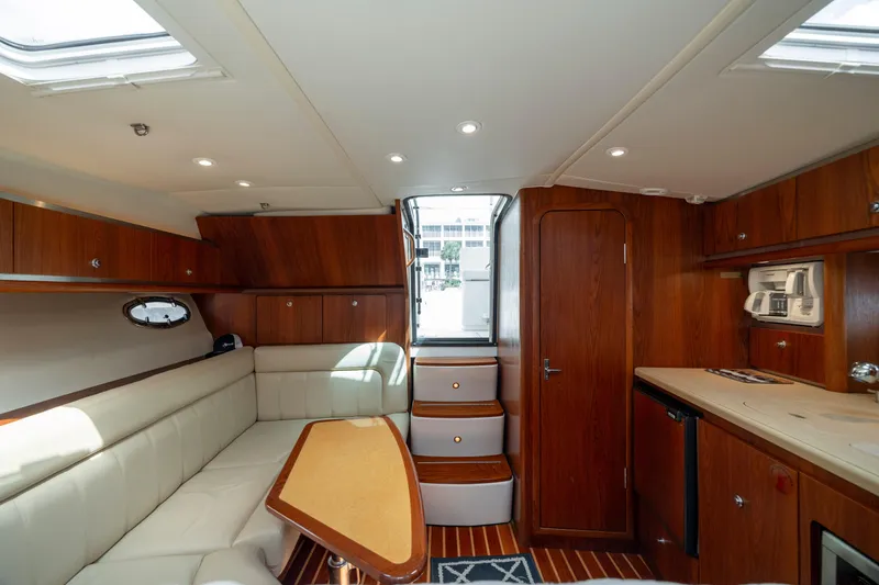 Slide: The Image of Luxurious interior of 2004 Tiara Yachts 3200 Open with wood finish and plush seating. - 36