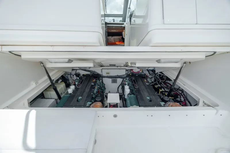 Slide: The Image of Engine compartment of 2004 Tiara Yachts 3200 Open, showcasing dual engines and mechanical components. - 37