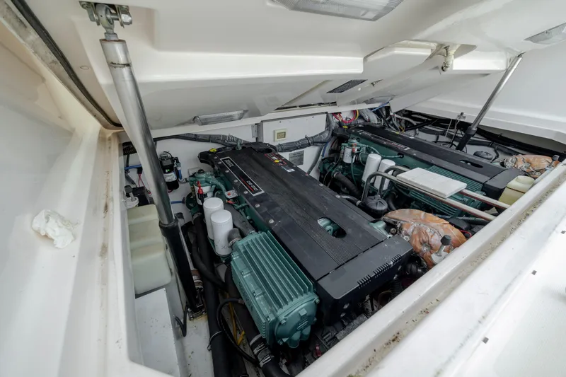 Slide: The Image of Engine compartment of 2004 Tiara Yachts 3200 Open, showcasing dual engines and mechanical components. - 38