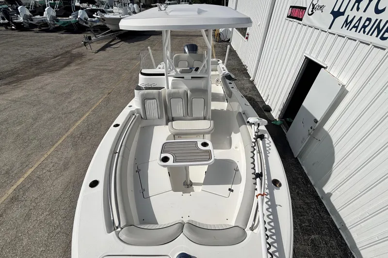 Slide: The Image of 2021 Sea Fox 249 Avenger boat with spacious seating and center console, docked at a marina. - 10