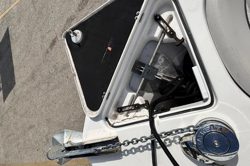 Slide: The Image of Anchor compartment of 2021 Sea Fox 249 Avenger boat with chain and winch. - 11
