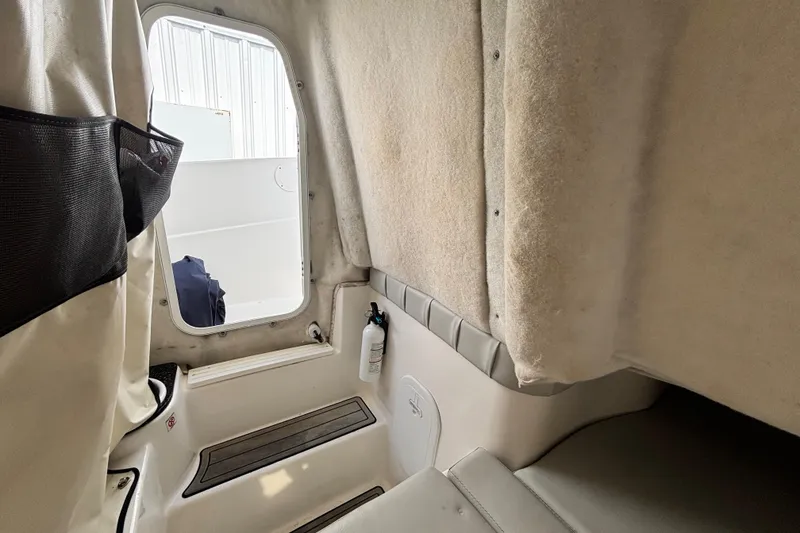 Slide: The Image of Interior view of 2021 Sea Fox 249 Avenger boat cabin with seating and storage. - 16