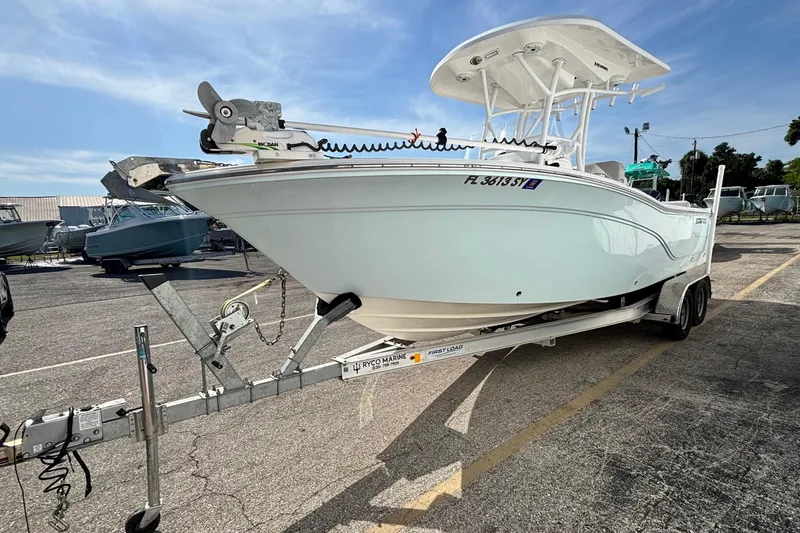 Slide: The Image of 2021 Sea Fox 249 Avenger boat on trailer in parking lot, sunny day. - 2