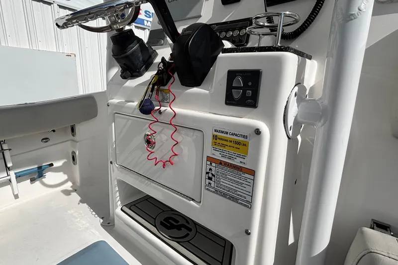 Slide: The Image of 2021 Sea Fox 249 Avenger boat console with capacity warning and controls. - 23