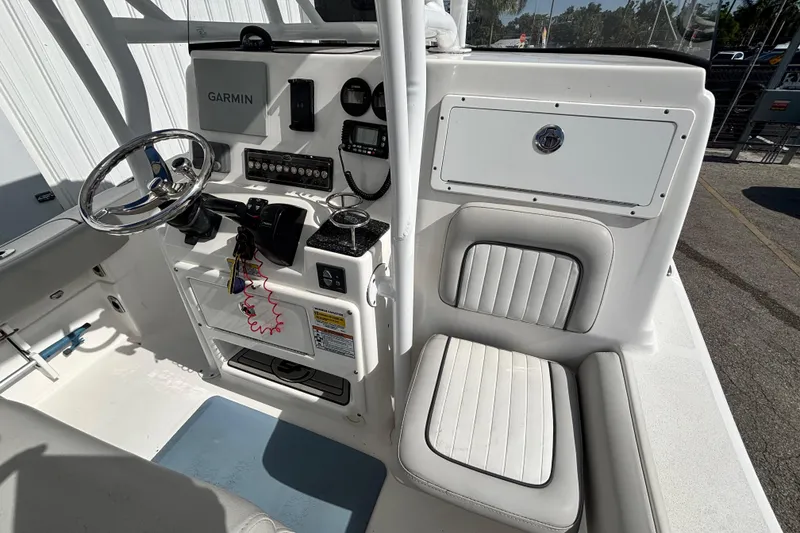 Slide: The Image of 2021 Sea Fox 249 Avenger boat cockpit with Garmin navigation and cushioned seating. - 25