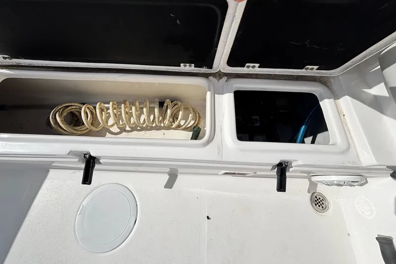 Slide: The Image of Storage compartments on a 2021 Sea Fox 249 Avenger boat, featuring coiled rope. - 30