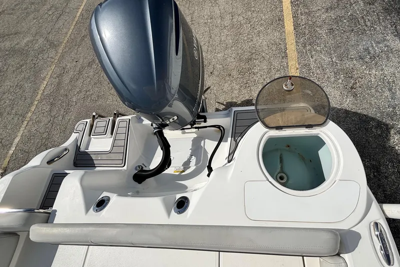 Slide: The Image of 2021 Sea Fox 249 Avenger boat deck with motor and open storage compartment. - 32