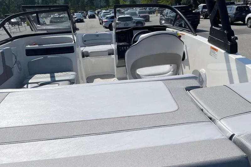 Slide: The Image of 2024 Bayliner VR5 Bowrider I/O interior with seating and dashboard, parked outdoors. - 4