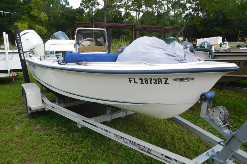 Slide: The Image of 2006 KEYWEST 1520 boat on trailer, parked on grass, with registration FL 2873RZ. - 2
