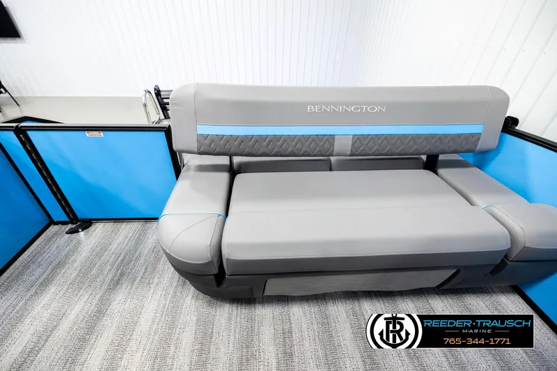 Slide: The Image of 2026 Bennington 22 MSBSE boat seating with gray and blue upholstery in showroom. - 15