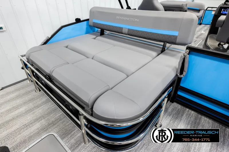 Slide: The Image of 2026 Bennington 22 MSBSE pontoon boat with gray and blue seating, showcased indoors. - 23