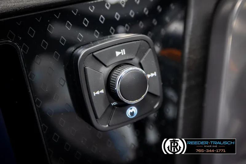 Slide: The Image of Close-up of 2026 Bennington 22 MSBSE audio control panel with volume knob. - 32