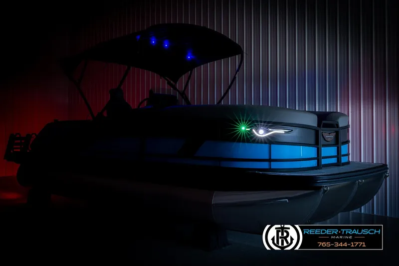 Slide: The Image of 2026 Bennington 22 MSBSE pontoon boat with illuminated features in a dimly lit setting. - 4