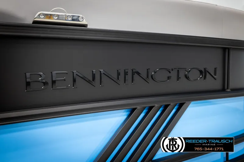 Slide: The Image of 2026 Bennington 22 MSBSE boat with sleek black and blue design, Reeder-Trausch Marine logo. - 48