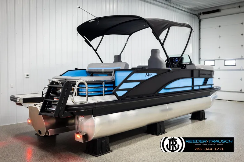 Slide: The Image of 2026 Bennington 22 MSBSE pontoon boat in showroom, featuring sleek design and modern amenities. - 6