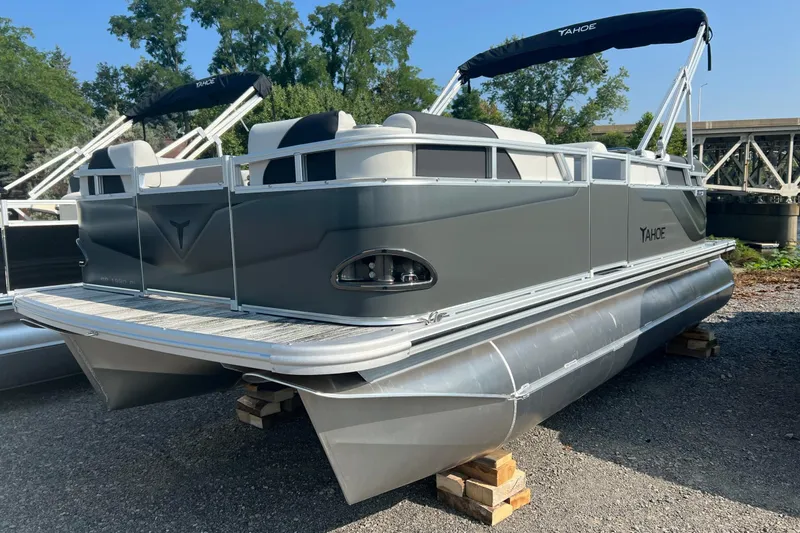 The Image of 2026 Tahoe Pontoon QUAD LOUNGE 1980, gray exterior, parked on blocks, outdoor setting. - 1