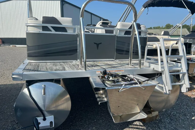 Slide: The Image of 2026 Tahoe Pontoon QUAD LOUNGE 1980 interior with sleek gray seating in a workshop. - 3