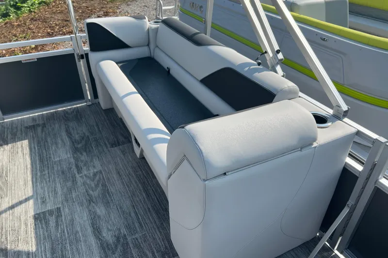Slide: The Image of 2026 Tahoe Pontoon QUAD LOUNGE 1980 in a garage, showcasing sleek design and seating. - 9