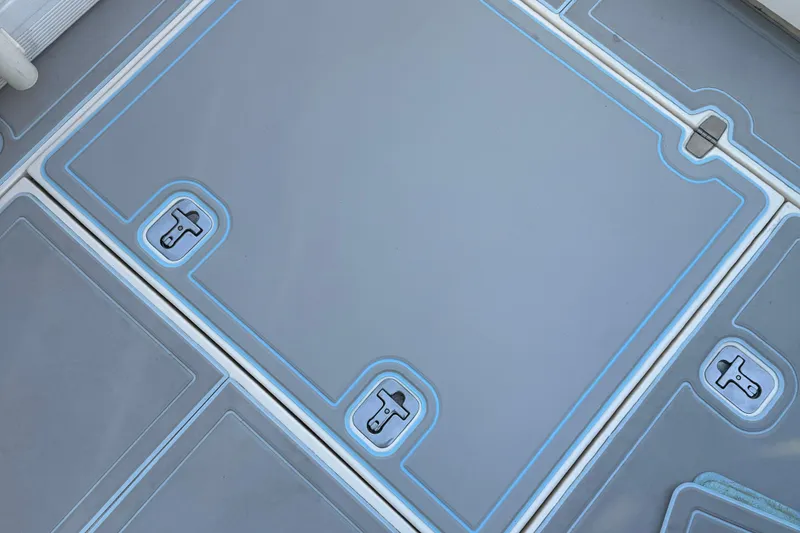 Slide: The Image of Deck of 2011 Pursuit OS 345 Offshore boat with storage compartments. - 16