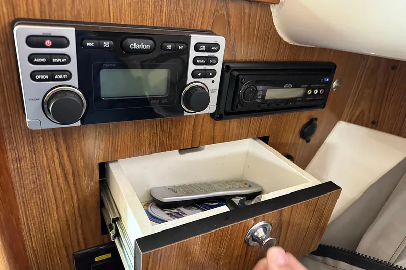 Slide: The Image of 2011 Pursuit OS 345 Offshore cabin with audio system and storage drawer. - 21