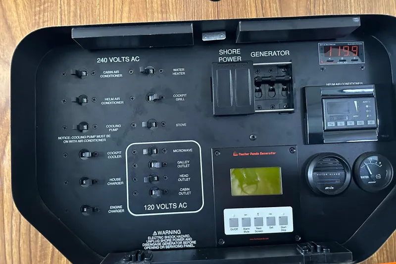 Slide: The Image of 2011 Pursuit OS 345 Offshore control panel with switches and gauges for electrical systems. - 23