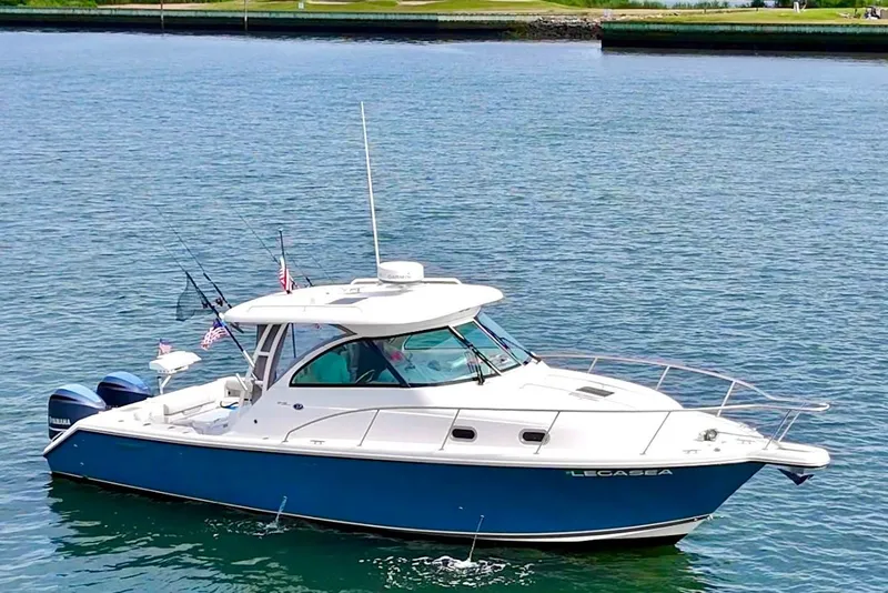 Slide: The Image of 2011 Pursuit OS 345 Offshore boat with dual Yamaha engines on calm water. - 3