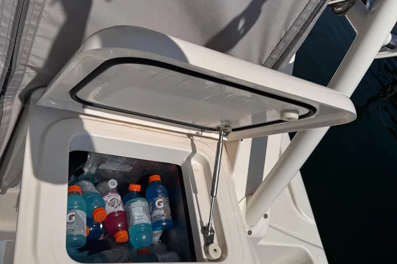 Slide: The Image of Open storage compartment on 2011 Pursuit OS 345 Offshore boat with drinks inside. - 31