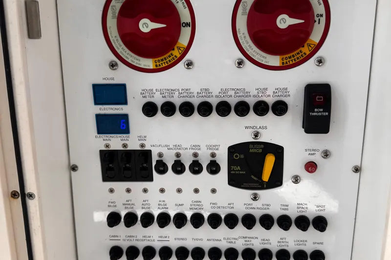 Slide: The Image of Control panel of a 2011 Pursuit OS 345 Offshore boat, featuring various switches and meters. - 33